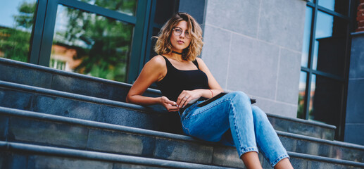 Stylish young woman leaning on stairs