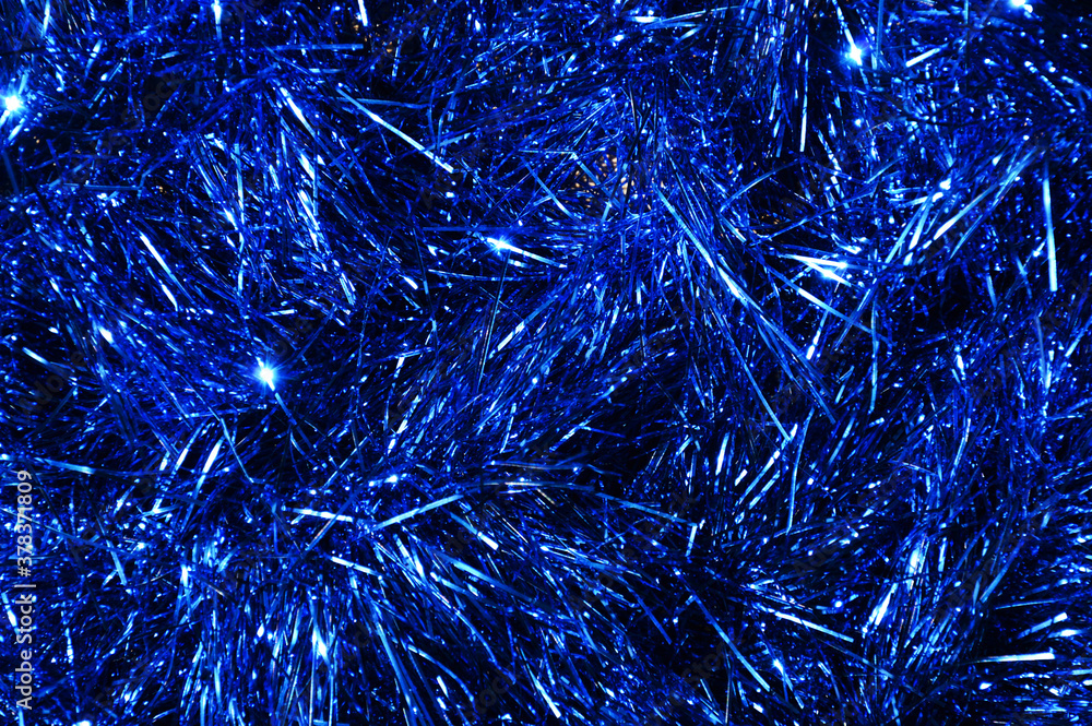 Wall mural blue shiny tinsel. background and texture for christmas and new year decorations.