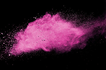 Pink powder explosion on black background. Paint Holi.
