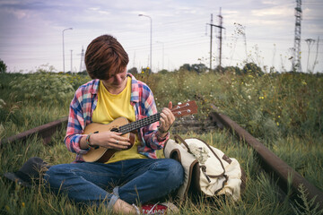 girl playing on ukulele