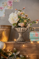 white bouquet of flowers stands on a shelf with garlands
