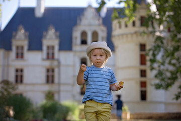Naklejka premium Cute child, toddler boy, eating ice cream in a park on a summer day