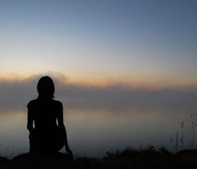 silhouette of person sitting on the ground