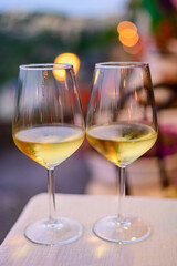 Two glasses of cold dry white wine served outdoor in cafe at night in Italy