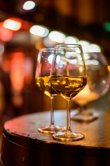 Two glasses of cold dry white wine served outdoor in cafe at night in Italy