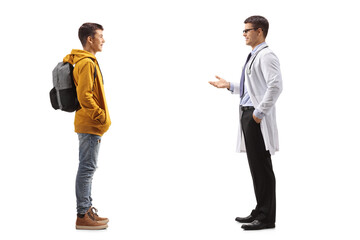 Full length profile shot of a teenager boy listening to a doctor
