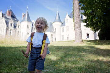 Child, walking in a park in front of a castle on Loire valley © Tomsickova