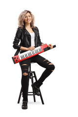 Fototapeta premium Portrait of a cool woman with a keytar synthesizer sitting on a chai