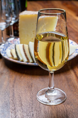 Spanish fino sherry wine from Andalusia and pieces of different sheep hard manchego cheeses made in La Mancha, Spain. Wine and cheese pairing