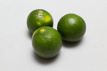 Isolated green lemon on white background