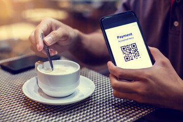 Selective  focus to payment QR code tag on smartphone with coffee in coffee shop or restaurant to accepted generate digital pay without money. Qr code payment concept.