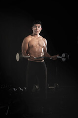 Fototapeta na wymiar Handsome man lifting Barbell,doing exercise for buit muscle,fit and firm body