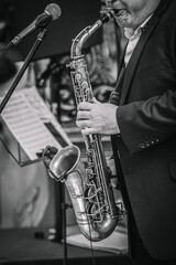  male musician playing saxophone close up