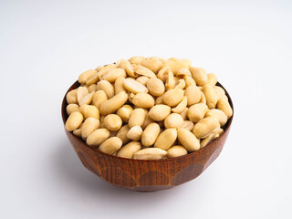 Peanuts in a wooden bowl on white background