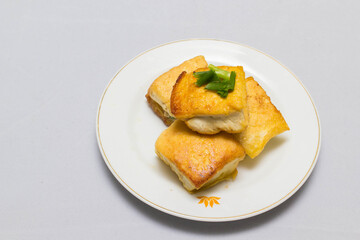 fried tofu blocks and fish sauce on white background