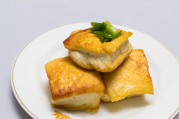 fried tofu blocks and fish sauce on white background