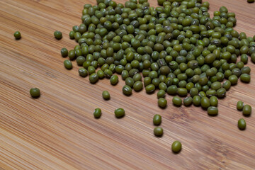 heart arranged by Green beans, wooden background isolated