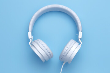 White headphone on blue background. Music concept.