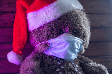 Teddy bear in a medical mask meets the new year