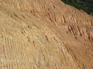 Erosion at ground and slopes is caused by rainfall. The soil structure is weak and there are landslide. Safety measure has been taken in some area.