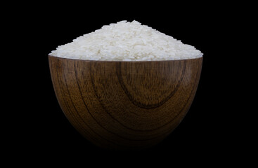 Rice in wooden bowl isolated on black