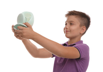 Little boy enjoying air flow from portable fan on white background. Summer heat