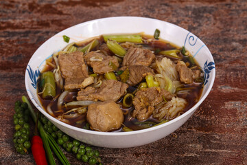 Thai style soup with meat and mushrooms