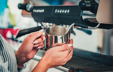 bartender preparing hot milk on coffee machine
