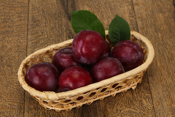 Plum heap in the wooden basket