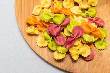 Raw homemade pasta and ingredients for pasta on wooden background