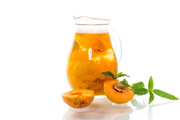 cold apricot compote in a glass decanter