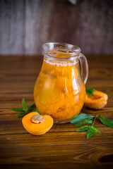 cold apricot compote in a glass decanter