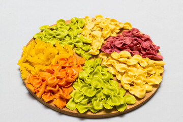 Raw homemade pasta and ingredients for pasta on wooden background