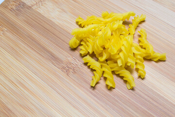Raw homemade pasta and ingredients for pasta on wooden background