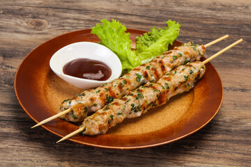 Minced pork skewer kebab with sauce