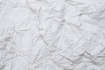 Crumpled white paper background.