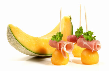 Fototapeta na wymiar Smoked Ham Slices with Melon - Isolated on white Background