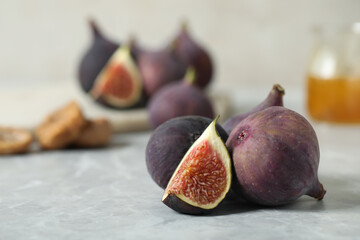 Tasty raw figs on light grey marble table, closeup