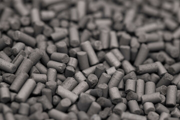 Activated carbon granules abstract background. Macro shot. Selective focus.