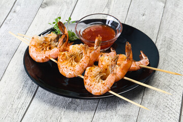 Grilled prawn skewer with sauce