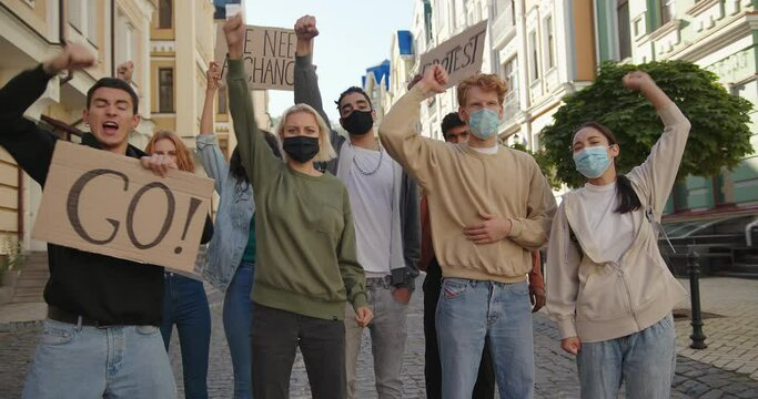 Multiracial protest demonstration, protesters wearing medical masks. Mass demonstration concept.