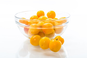 yellow cherry plums on the white background