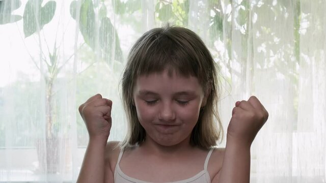 funny little eight-year-old caucasian girl can barely contain her rage. Mind blown reaction of girl expressing her shock of something unbelievable. excited girl showing gesture of brain explosion