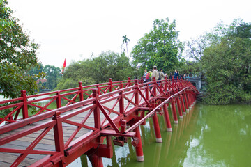 The Huc Bridge or Sun shine bridge at Hoan Kiem Lake, It`s a red wooden arch bridge.

