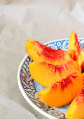 Fototapeta na wymiar Slices of juicy ripe and sweet peach. Seasonal summer fruits.