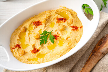 hummus paste with lemon and chilli on white background