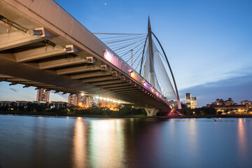 Fototapeta na wymiar bridge at twilight time with clear sky along river