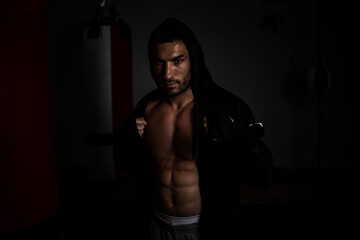 Fototapeta na wymiar Portrait of a young boxer, kick boxer ready for training
