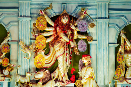Happy Durga Puja background. Hindu Goddess Maa Durga idol shot at a puja pandal. Indian religious festival Navaratri, Bijaya dashami celebration. Traditional Bengali culture 