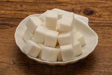Refined white sugar cubs in the bowl